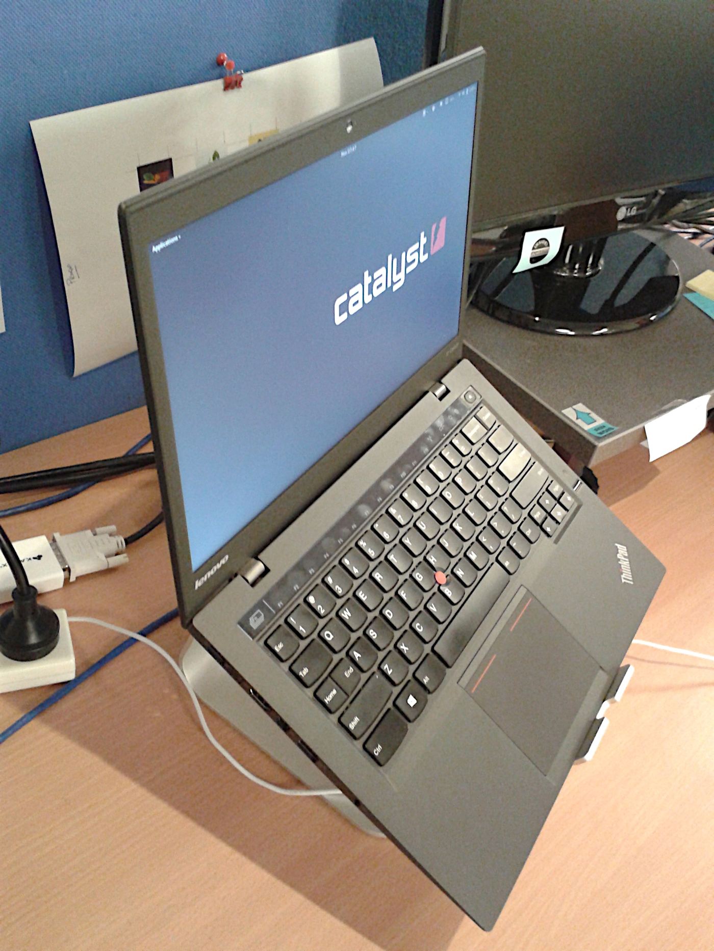 Photograph of investment charts displayed on a laptop on a desk.